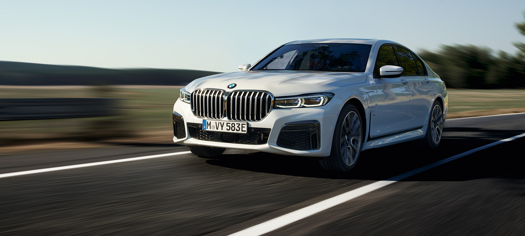 BMW 7 Series Sedan plug-in hybrid G11 G12 three-quarter front view driving on the street